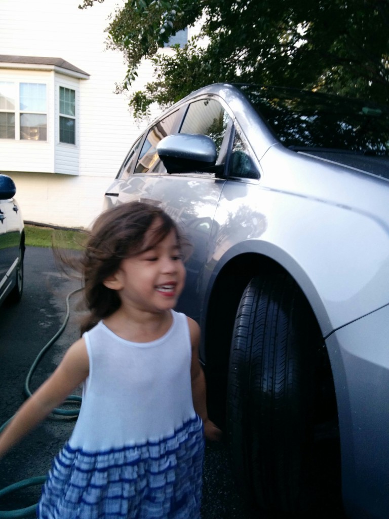 Scarlett's pure joy at running through puddles after we washed the cars.