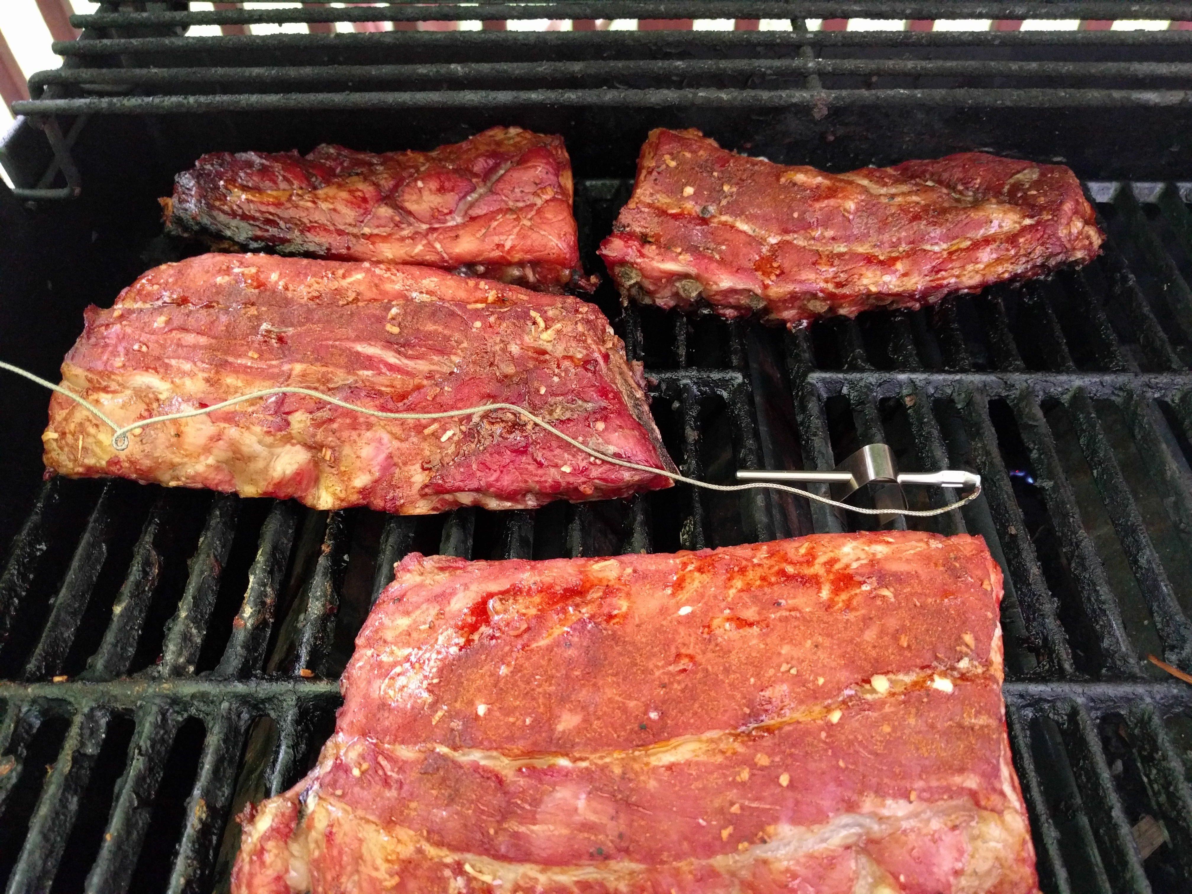 Ribs on the grill with the thermometer probe
