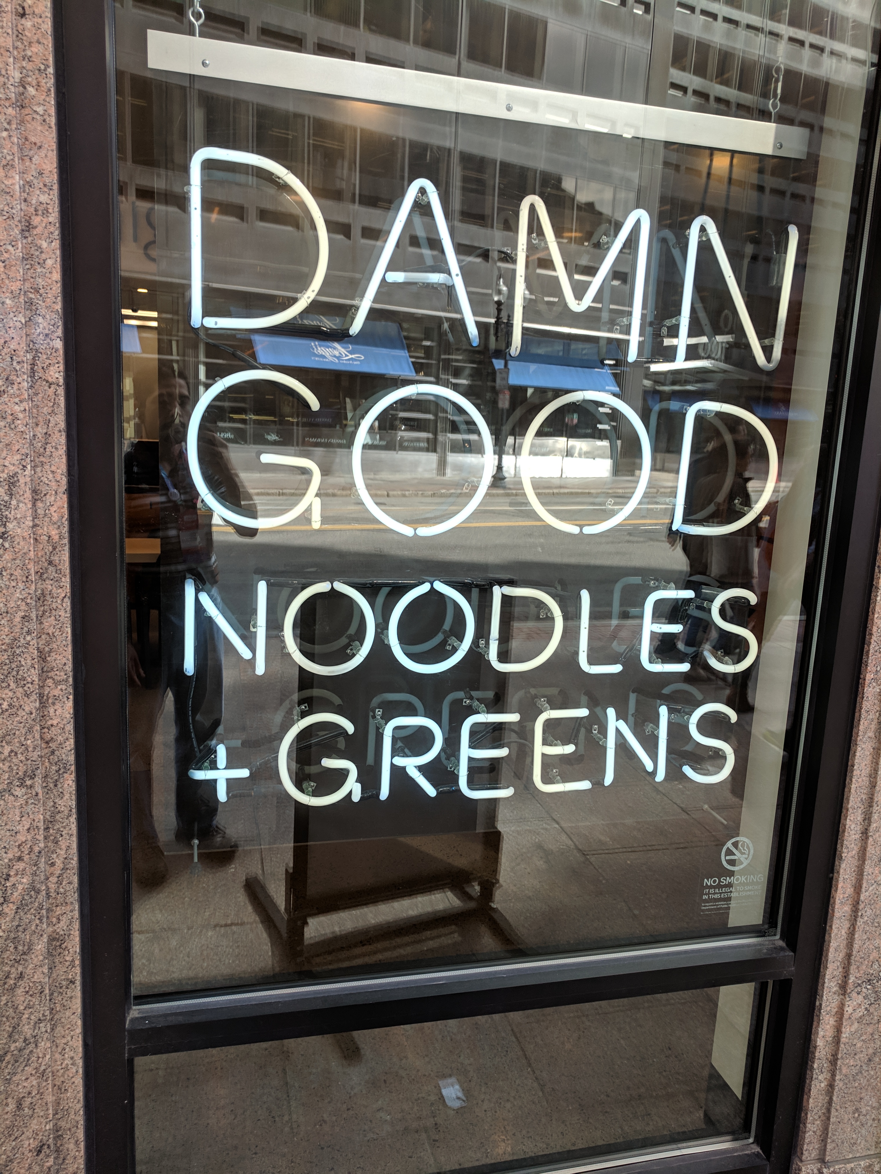 a sign that reads "Damn good noodles"