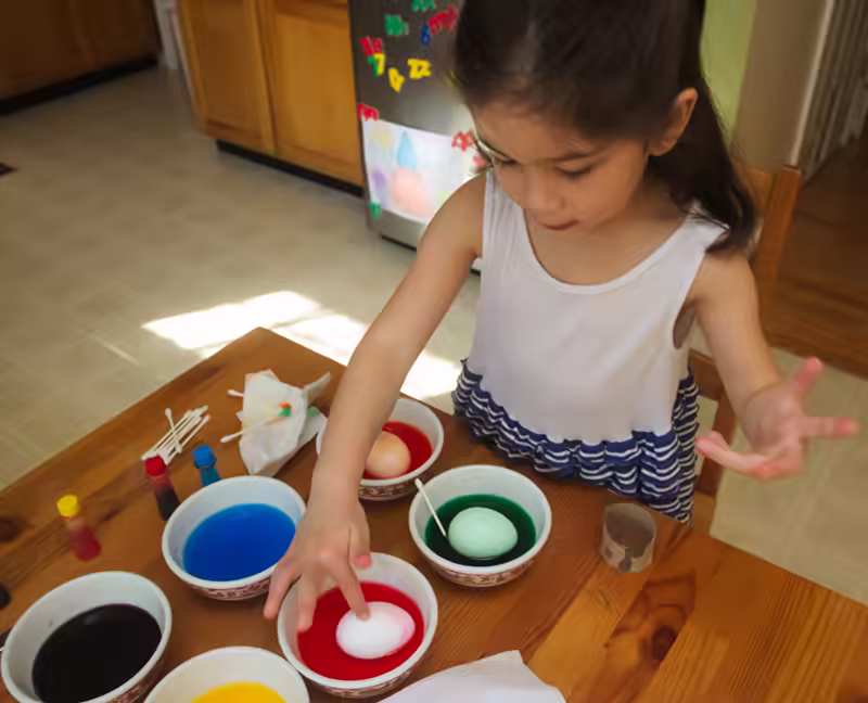 Scarlett dipping eggs