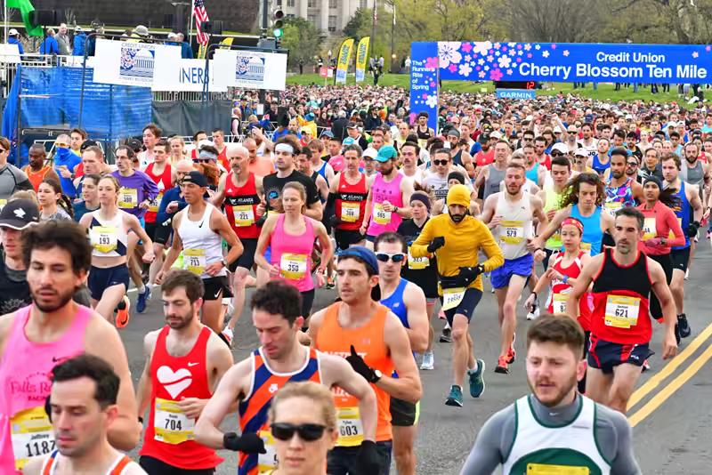 Many thousands of runners begin to cross the starting line