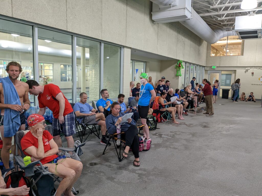 many people sitting poolside