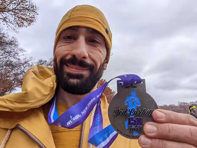 self-portrait holding race medal