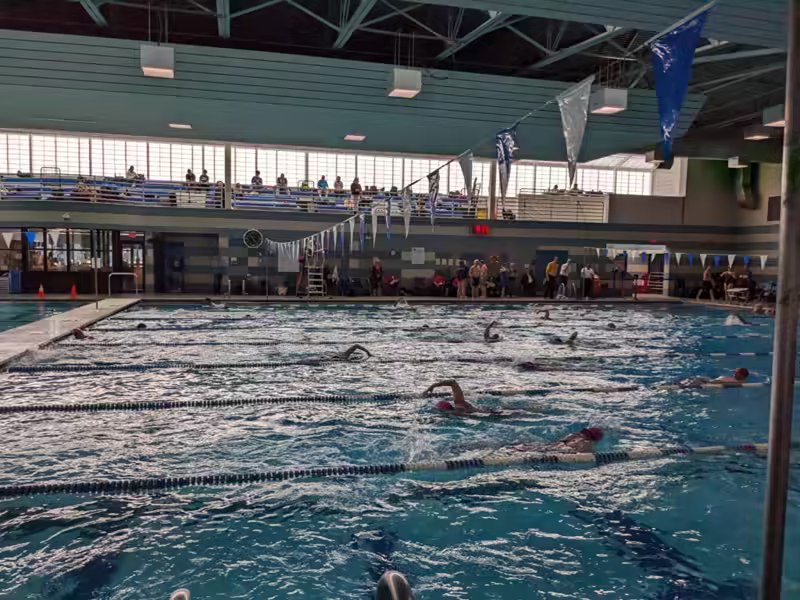 swimmers warming up in the main area of the the Arundel Olympic Swim Center
