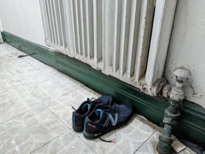 racing shoes by the wall in a hallway