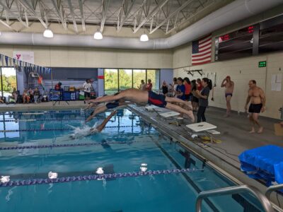 swimmers jumping off the starting blocks
